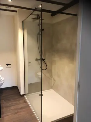 a glass shower in a bathroom with a toilet at De Pelgrim in Tongeren