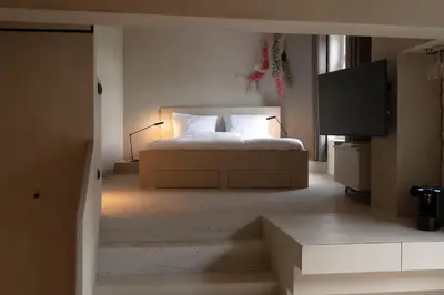 a bedroom with a bed and a tv in a room at Luxe in Het Posthuis - nieuwe Stijlvolle Verblijven in Oud-Rekem in Lanaken