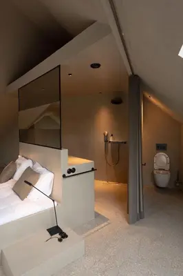 a bedroom with a bed and a shower and a toilet at Luxe in Het Posthuis - nieuwe Stijlvolle Verblijven in Oud-Rekem in Lanaken