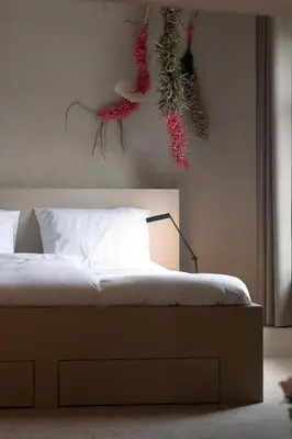 a bedroom with a bed with flowers on the wall at Luxe in Het Posthuis - nieuwe Stijlvolle Verblijven in Oud-Rekem in Lanaken