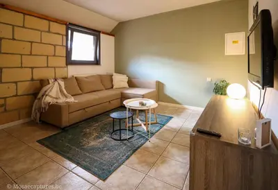 a living room with a couch and a table at Millenniumhoeve (Lieke) in Riemst
