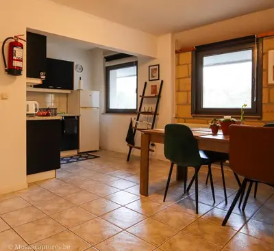 a kitchen and dining room with a table and chairs at Millenniumhoeve (Lieke) in Riemst