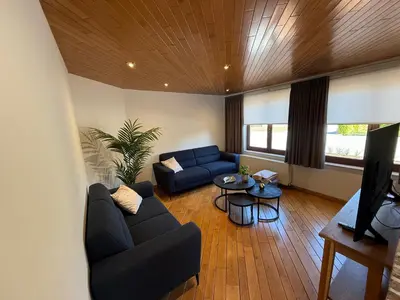 a living room with a couch and a table at Villa Luna in Oudsbergen