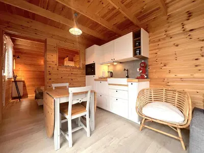 a kitchen with a table and chairs in a cabin at Chalet Wielsmer in Zutendaal