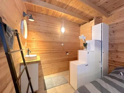 a small bathroom with a refrigerator and a sink at Chalet Wielsmer in Zutendaal