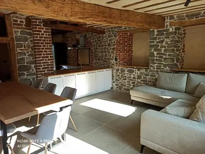 a kitchen and living room with a table and a couch at Close from Ardenne - Fully renovated modern farmhouse in Baelen in Baelen
