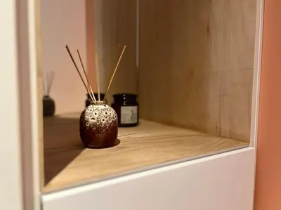 a vase sitting on a shelf with sticks in it at L'escapade chic - Cathédrale, Saint Lambert in Liège
