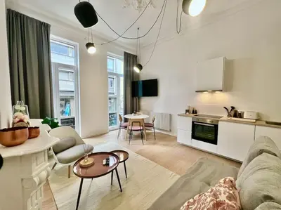 a living room with a couch and a table at L'escapade chic - Cathédrale, Saint Lambert in Liège