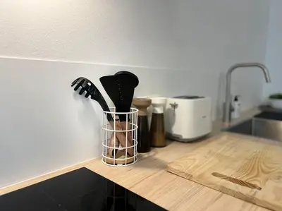 a kitchen counter with a container of kitchen utensils at L'escapade chic - Cathédrale, Saint Lambert in Liège