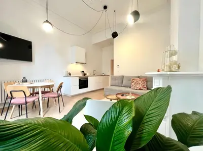 a living room with a couch and a table at L'escapade chic - Cathédrale, Saint Lambert in Liège