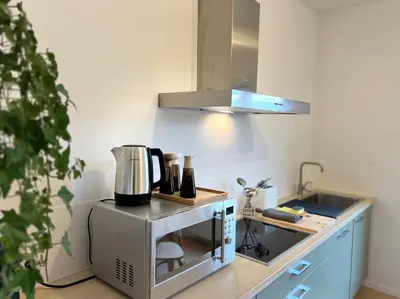 a kitchen with a counter with a coffee maker at Duplex chic et spacieux - Hypercentre in Liège