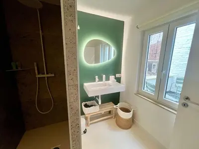 a bathroom with a sink and a mirror at Duplex chic et spacieux - Hypercentre in Liège