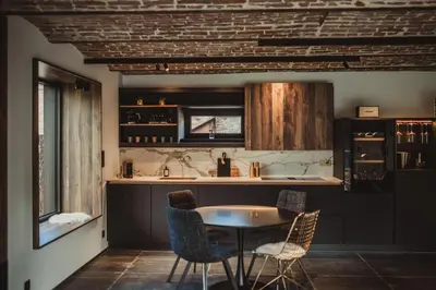 a kitchen with a table and chairs and a counter at L’exclusif in Aubel