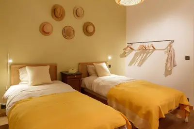 a bedroom with two beds with yellow sheets at Superbe loft de caractère avec garage à 10' du centre in Liège