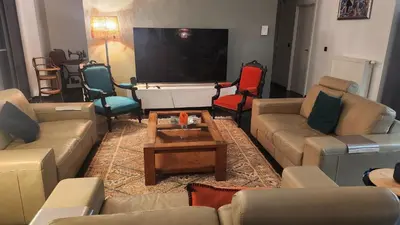 a living room with couches and a flat screen tv at Superbe loft de caractère avec garage à 10' du centre in Liège