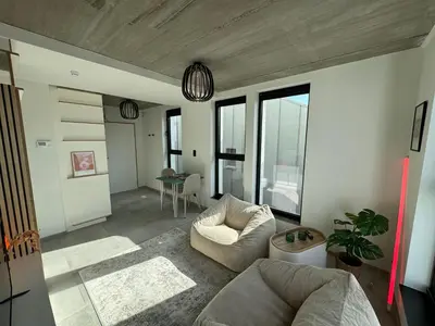 a living room with a couch and a table at PentHouse 5.01 in Liège