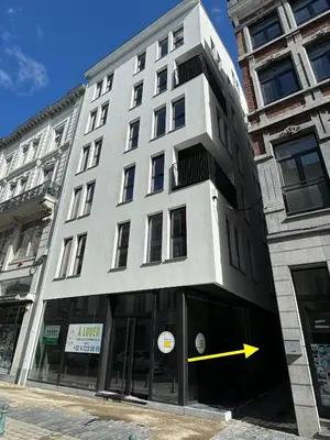 a building with a yellow arrow in front of it at PentHouse 5.01 in Liège
