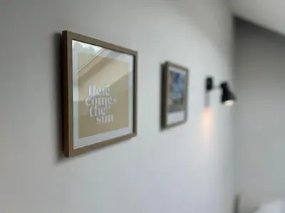 a picture hanging on a wall with three pictures at Le Belvédère de la Rose-Hors château, hypercentre in Liège