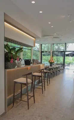 a row of tables and chairs in a restaurant at Hôtel Les Fines Gueules in Herve