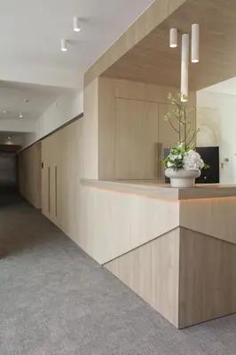 a lobby with a vase of flowers on a counter at Hôtel Les Fines Gueules in Herve
