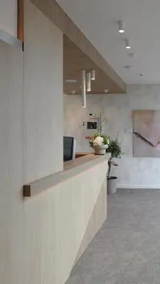 an office lobby with a counter with a laptop on it at Hôtel Les Fines Gueules in Herve