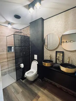 a bathroom with two sinks and a toilet at Tranquilo Maaseik in Maaseik