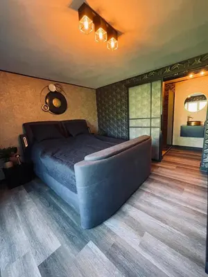 a bedroom with a large bed in a room at Tranquilo Maaseik in Maaseik