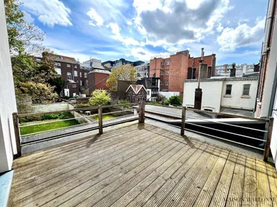 a balcony with a view of a city at Le Botanique des Augustins -100m2 en plein centre in Liège