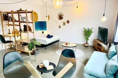 a living room with a blue couch and a table at Le parfait Studio de la Cité Ardente - Central in Liège