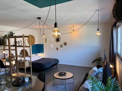 a living room with a couch and a bed at Le parfait Studio de la Cité Ardente - Central in Liège