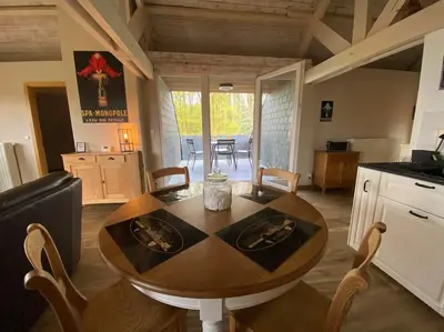 a kitchen and dining room with a table and chairs at La réserve by la Villa KerKus in Fraipont