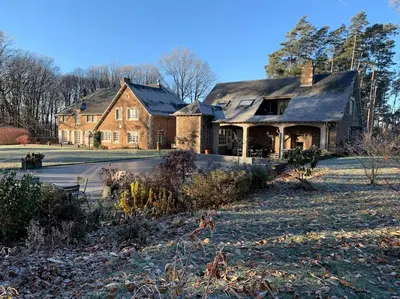 a large brick house with a roof at La réserve by la Villa KerKus in Fraipont