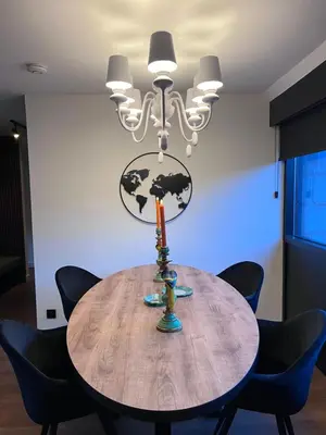 a dining room table with a chandelier at Garden Street Lommel - The Green Haven in Lommel