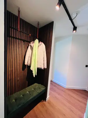 a room with a wooden wall with a green bench at Garden Street Lommel - The Green Haven in Lommel