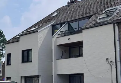a white house with a gray roof at Garden Street Lommel - The Green Haven in Lommel
