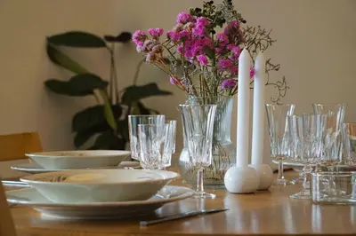 a table with plates and candles and flowers on it at Stijlvol App in Genk Centrum in Genk