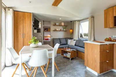 a kitchen and living room with a table and a couch at Vakantiehuis Hoge Kempen - 25 minuten Roermond, Maasmechelen & Maastricht in Kinrooi