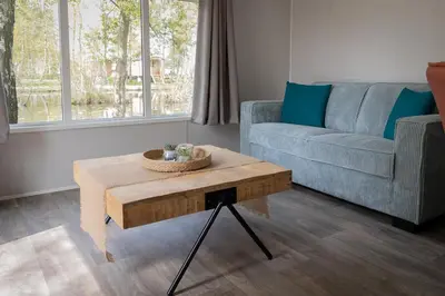 a living room with a couch and a coffee table at Vakantiehuis Hoge Kempen - 25 minuten Roermond, Maasmechelen & Maastricht in Kinrooi