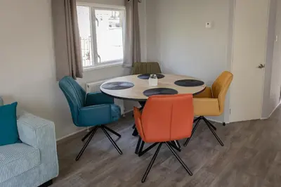 a dining room with a table and chairs at Vakantiehuis Hoge Kempen - 25 minuten Roermond, Maasmechelen & Maastricht in Kinrooi