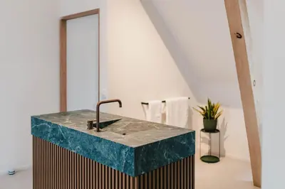 a bathroom with a marble sink and a mirror at Entre Nous in Herk-de-Stad