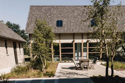 a house with a table and chairs in front of it at Entre Nous in Herk-de-Stad