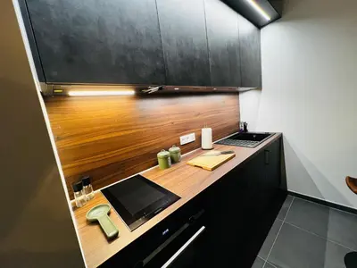 a kitchen with a desk with a laptop on it at TB Trianon - Appartement Chic & Cosy in Liège