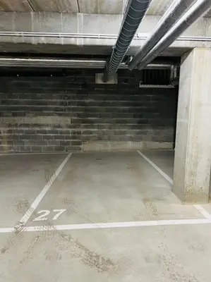 an empty parking lot in a parking garage at TB Trianon - Appartement Chic & Cosy in Liège