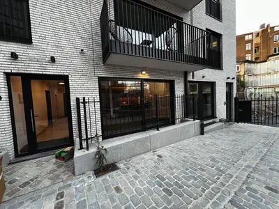 a brick building with a balcony on top of it at TB Trianon - Appartement Chic & Cosy in Liège