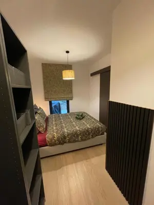a small bedroom with a bed and a window at TB Trianon - Appartement Chic & Cosy in Liège