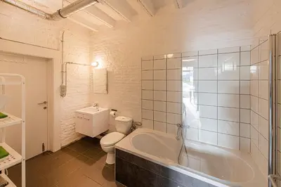 a bathroom with a tub and a toilet and a sink at 
