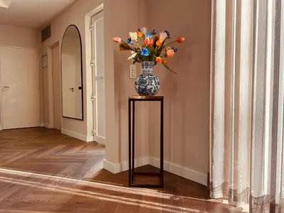 a vase of flowers on a table in a hallway at Vakantievilla 't Boshuys in Lommel