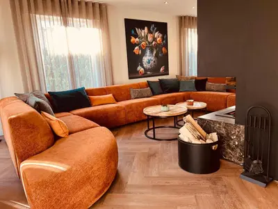 a living room with a couch and a table at Vakantievilla 't Boshuys in Lommel