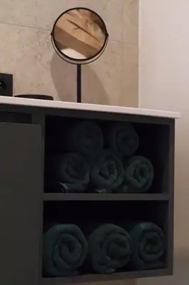 a shelf with a mirror and a pile of donuts at Maas & Me in Dilsen-Stokkem