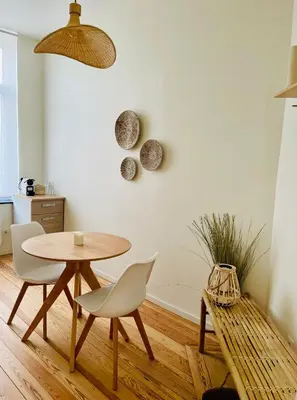 a dining room with a table and chairs at Chaleureux petit appartement in Liège